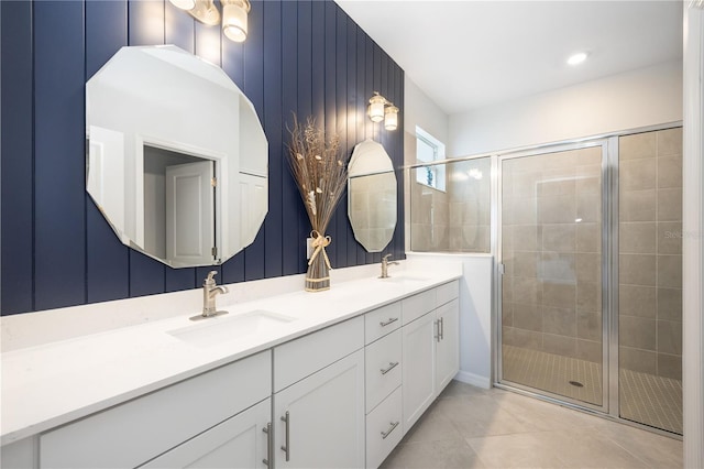 bathroom featuring tile patterned floors, vanity, and a shower with door