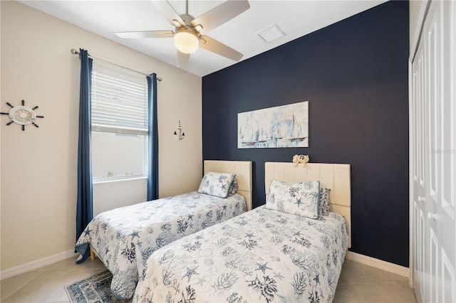 bedroom with ceiling fan and light tile patterned floors