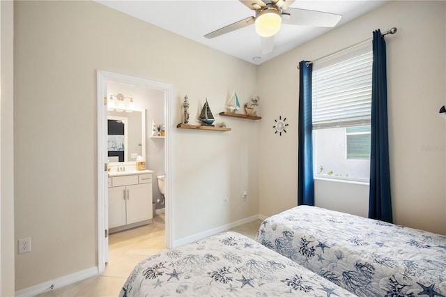 tiled bedroom with multiple windows, sink, connected bathroom, and ceiling fan