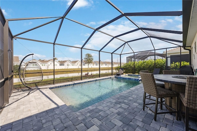 view of pool featuring a water view, an in ground hot tub, a lanai, and a patio