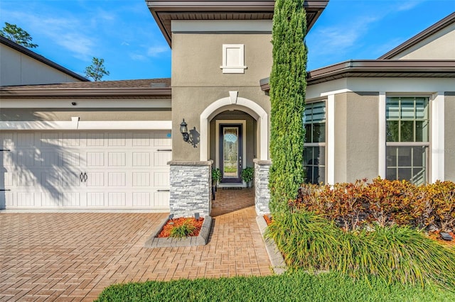 view of exterior entry featuring a garage