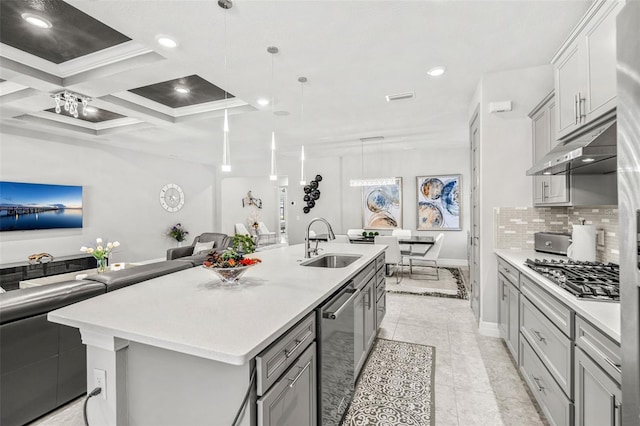 kitchen featuring gray cabinets, sink, decorative backsplash, hanging light fixtures, and a large island