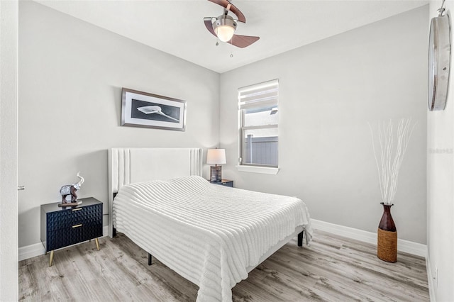 bedroom with light hardwood / wood-style flooring and ceiling fan