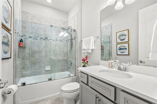 full bathroom featuring vanity, tile patterned flooring, toilet, and combined bath / shower with glass door