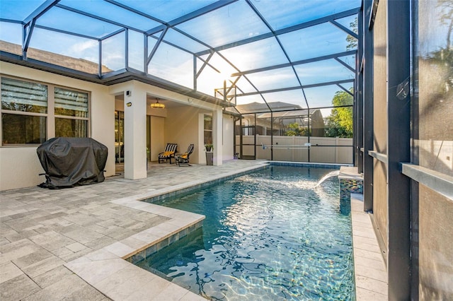 view of swimming pool featuring a patio, a lanai, and area for grilling