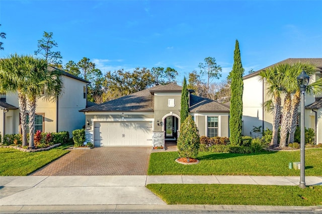 view of front facade with a garage and a front yard