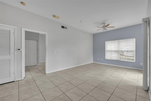 unfurnished room featuring light tile patterned flooring and ceiling fan