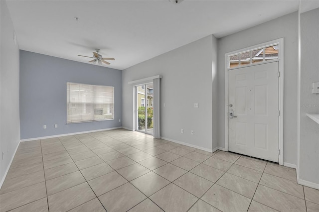 foyer with light tile patterned floors and ceiling fan