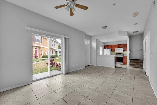 unfurnished living room featuring light tile patterned flooring and ceiling fan