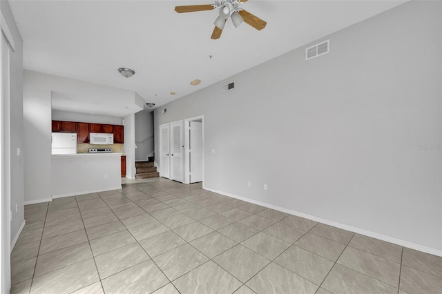 unfurnished living room with light tile patterned floors and ceiling fan