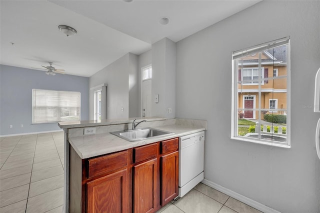 kitchen featuring light tile patterned flooring, sink, white dishwasher, kitchen peninsula, and ceiling fan