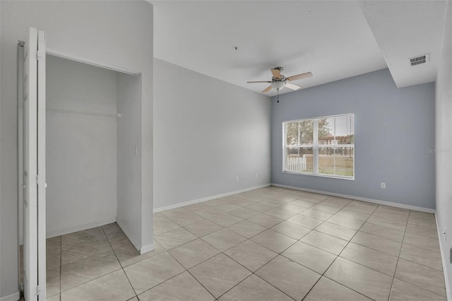 unfurnished bedroom featuring ceiling fan, a closet, and light tile patterned floors