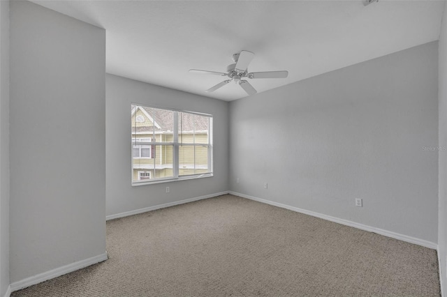 unfurnished room with light colored carpet and ceiling fan