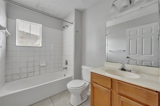 full bathroom featuring tile patterned floors, vanity, toilet, and tiled shower / bath