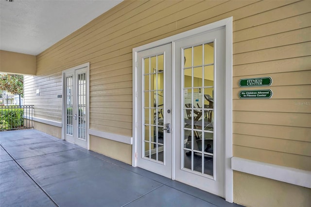 property entrance with a patio area and french doors