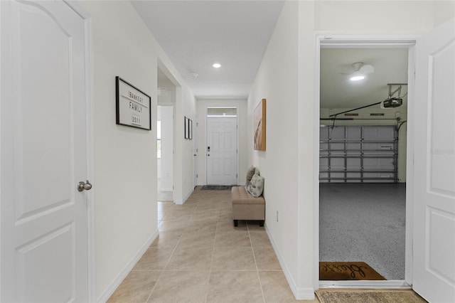 hall featuring light tile patterned floors