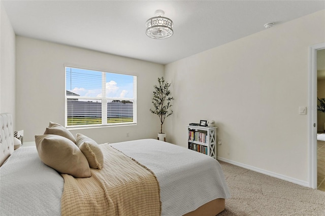 bedroom featuring light carpet