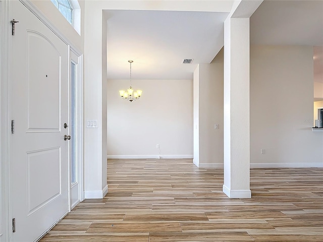 interior space featuring light hardwood / wood-style flooring and a chandelier