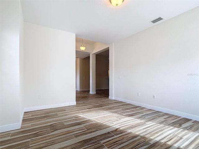 spare room featuring wood-type flooring