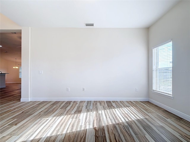 unfurnished room with light wood-type flooring