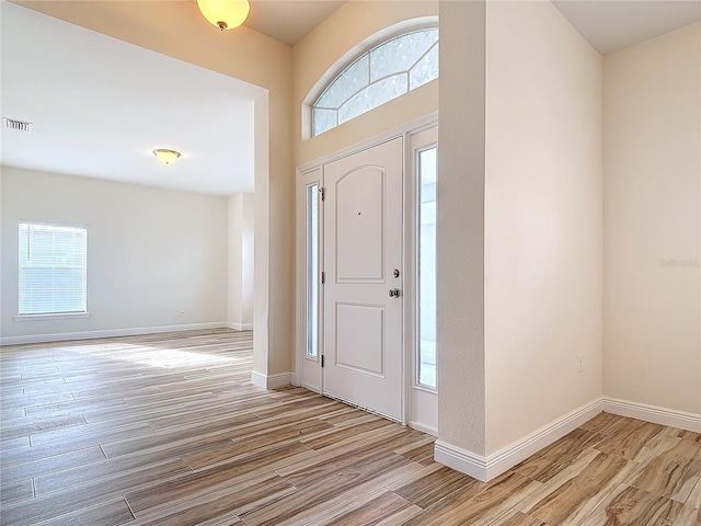 foyer featuring plenty of natural light and light hardwood / wood-style flooring