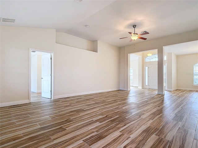 empty room featuring vaulted ceiling and ceiling fan