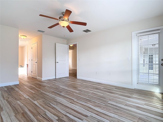 spare room featuring ceiling fan and light wood-type flooring