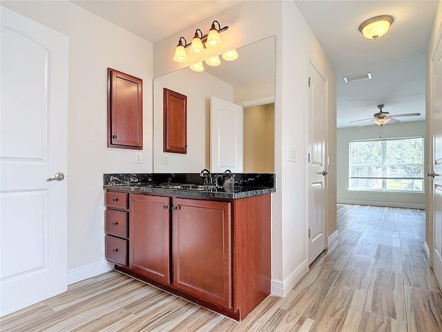 bathroom featuring ceiling fan and vanity