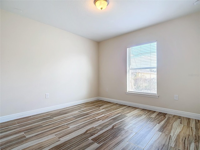 empty room with hardwood / wood-style flooring