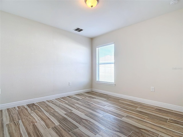 spare room featuring light hardwood / wood-style flooring