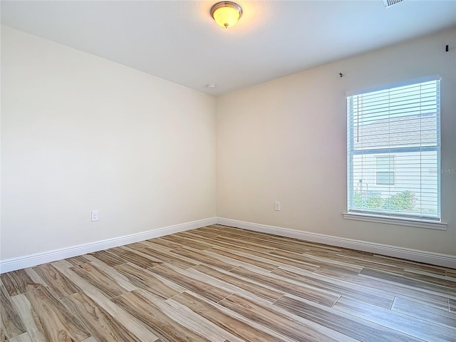 unfurnished room with light wood-type flooring