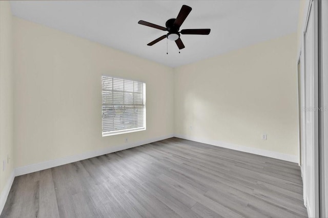 spare room with light hardwood / wood-style flooring and ceiling fan