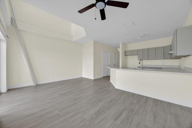 unfurnished living room with ceiling fan and light hardwood / wood-style floors