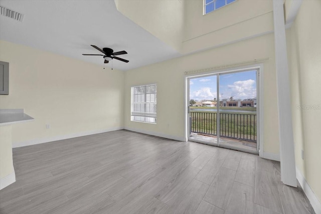 unfurnished living room featuring ceiling fan and light hardwood / wood-style flooring