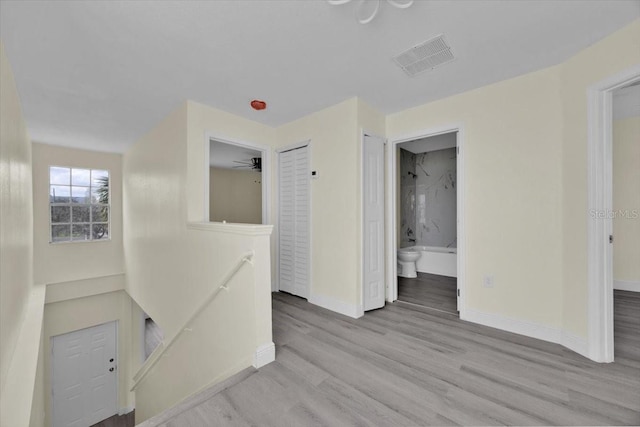 hallway with light hardwood / wood-style floors