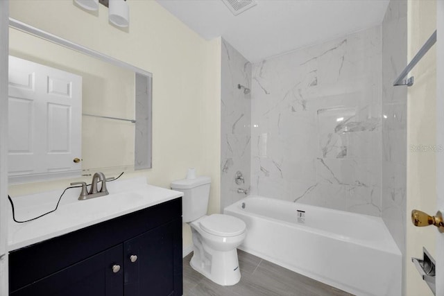 full bathroom with vanity, toilet, and tiled shower / bath combo