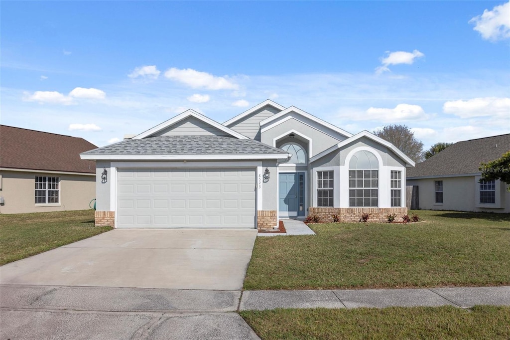 view of front facade with a garage and a front yard