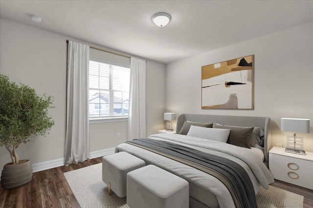 bedroom with dark hardwood / wood-style flooring