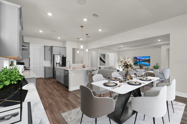 dining room with sink and dark hardwood / wood-style floors