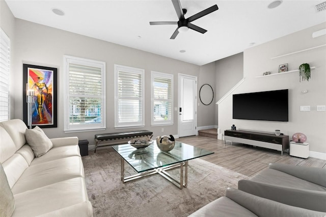 living room featuring ceiling fan and hardwood / wood-style floors