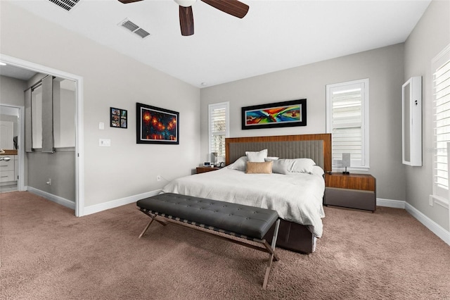 carpeted bedroom featuring multiple windows and ceiling fan