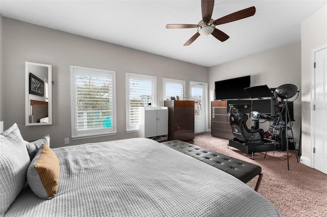 carpeted bedroom featuring multiple windows and ceiling fan