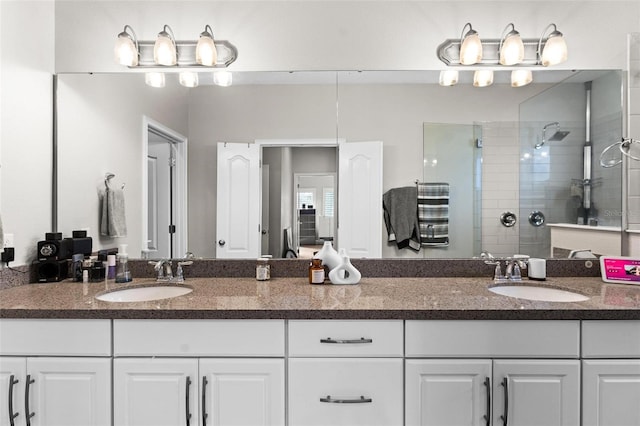 bathroom featuring vanity and tiled shower