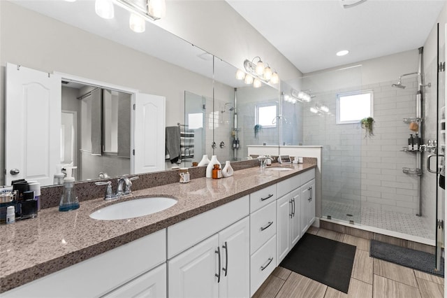 bathroom featuring vanity and a shower with shower door
