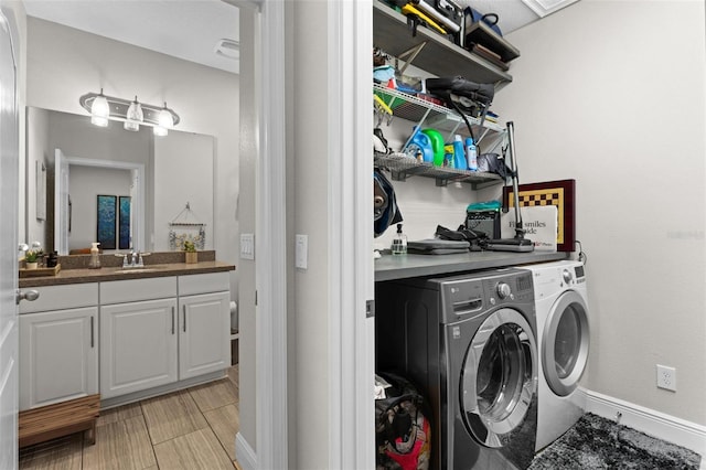 laundry room with separate washer and dryer and sink