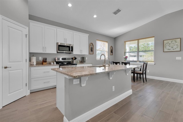 kitchen with white cabinetry, an island with sink, appliances with stainless steel finishes, and sink