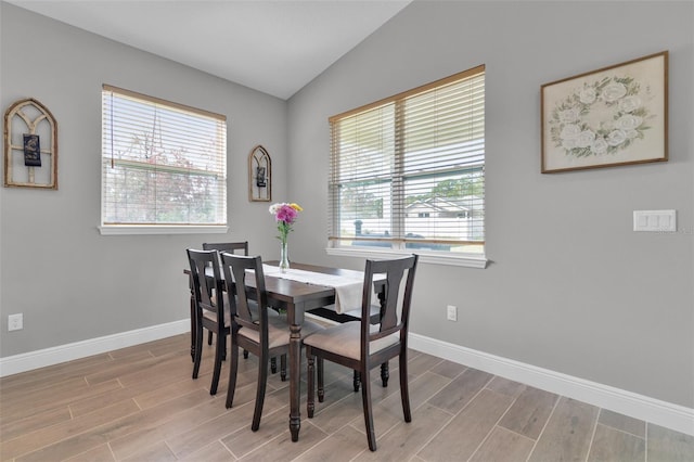 dining room featuring lofted ceiling