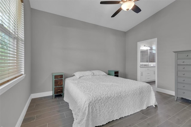 bedroom featuring vaulted ceiling, ceiling fan, and ensuite bath