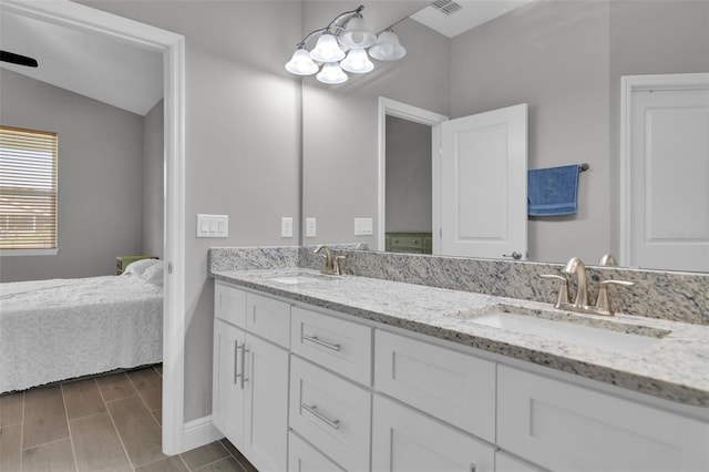 bathroom featuring vanity and lofted ceiling