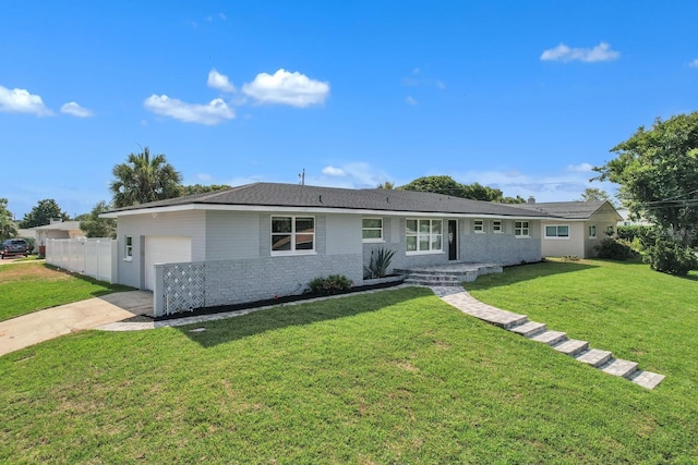 ranch-style home with a garage and a front lawn